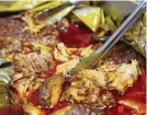  ??  ?? After cooking in the oven for 10 to 12 hours, cochinita pibil is tender and juicy.