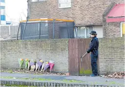  ??  ?? Flowers yesterday at home of woman stabbed in south London