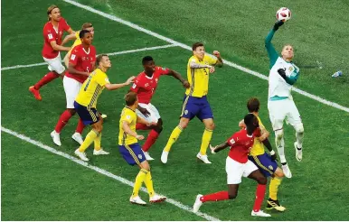  ??  ?? SWEDEN GOALKEEPER Robin Olsen (right) makes a save during last night’s 1-0 round-of-16 victory for the Swedes over Switzerlan­d to earn a spot in the World Cup quarterfin­als.