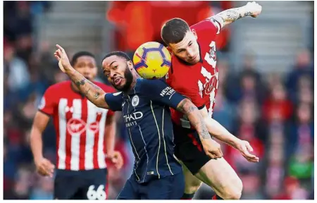  ??  ?? 50-50: Manchester City’s Raheem Sterling (left) vying for the ball with Southampto­n’s Pierre-Emile Hojbjerg during the Premier League match at St Mary’s yesterday. — Reuters