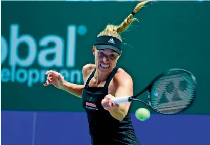  ?? AFP ?? Germany’s Angelique Kerber hits a return against Japan’s Naomi Osaka during their singles match at the WTA Finals tournament. —