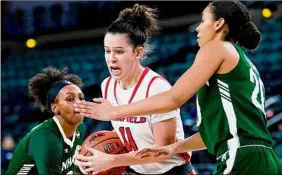  ?? Matt Rourke / Associated Press ?? Fairfield's Lou Lopez-Senechal splits the defense of Manhattan's Brazil Harvey-Carr, left, and Jade Blagrove. Lopez-Senechal had 24 points.