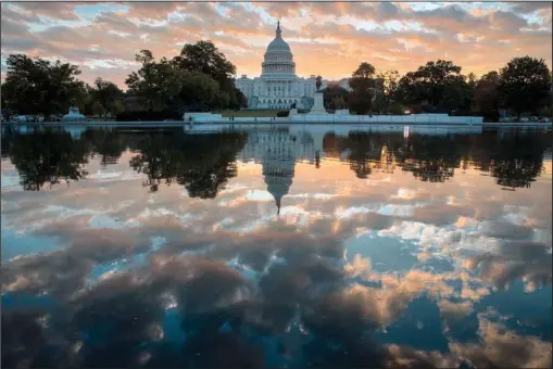  ?? The Associated Press ?? SUNRISE: he Capitol is seen at sunrise on Oct. 10 in Washington. The crush of unfinished business facing lawmakers when they return to the Capitol this week would be daunting even if Washington were functionin­g at peak efficiency.