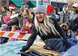  ?? NICK GRAHAM / STAFF ?? Kayla Harrison engages the crowd as grand marshal for the Santa Parade kicking off Middletown Holiday Whopla events in 2021 in Middletown.