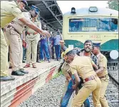  ??  ?? Police remove a protester from the railway track in Chennai on Saturday. PTI PHOTO