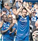  ??  ?? Tribute: John Terry is substitute­d and leaves the pitch with a guard of honour