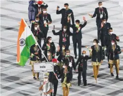  ?? Agence France-presse ?? ↑
The Indian delegation parade during the opening ceremony of the Tokyo 2020 Olympic Games.