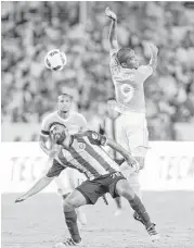  ?? Wilf Thorne ?? Mauro Manotas (19) of the Dynamo heads the ball toward the goal in front of Miguel Basalt (28) of Guadalajar­a in a friendly at BBVA Compass Stadium.