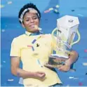  ?? JOHN RAOUX/AP ?? Zaila Avant-garde, 14, celebrates with the championsh­ip trophy after winning the 2021 Scripps National Spelling Bee on July 8 at Disney World.