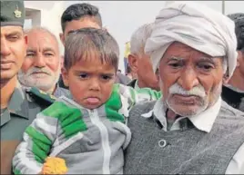  ??  ?? Havildar Baljeet Singh's father with his grandson during the cremation at Dinger Majra village of Karnal■ on Wednesday HT PHOTO