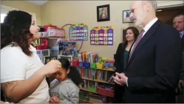  ?? MARK MORAN/THE CITIZENS’ VOICE VIA AP ?? Pennsylvan­ia Gov. Tom Wolf talks with Misericord­ia University student and mother Rochelle Jade Scott and her daughter Sky as he visited Misericord­ia University in Dallas, Pa., Friday, Feb. 8, 2019, to tour the Ruth Matthews Bourger Women with Children Program and to outline his bold budget plan to create the strongest workforce in the nation.