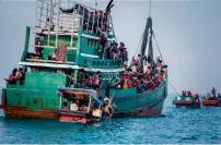  ?? AFP ?? Rohingya migrants resting on a boat off the coast near Kuala Simpang Tiga in Indonesia’s East Aceh district of Aceh province before being rescued. —