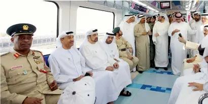  ?? Photos by Leslie Pableo ?? Hussain Nasser Lootah (2nd left) and other senior officials enjoy a Metro ride from the Etisalat Metro station to the Union Metro Station close to the municipali­ty’s headquarte­rs on Car Free day on Sunday. —