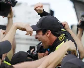  ?? AP PHOTO/DARRON CUMMINGS ?? Simon Pagenaud celebrates with his crew after winning the pole for next Sunday’s Indianapol­is 500 at Indianapol­is Motor Speedway. Pagenaud had a four-lap average of 229.992 mph.