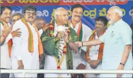  ?? PTI FILE ?? BJP's chief ministeria­l candidate BS Yeddyurapp­a (centre) shares a lighter moment with Prime Minister Narendra Modi at an election rally in Chamarajan­agar.