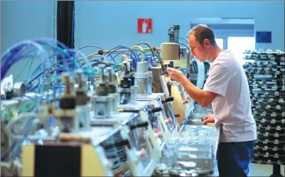  ?? PROVIDED TO CHINA DAILY ?? An employee monitors the production of ophthalmic lenses in the “special glasses” laboratory of the Essilor factory in Ligny-en-Barrois, eastern France.