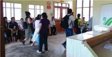  ??  ?? Villagers waiting for their names to be called at Ba Kelalan airport.