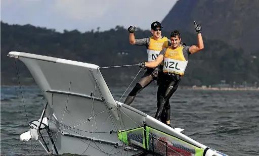  ??  ?? Peter Burling and Kerikeri’s Blair Tuke capsized their boat in celebratio­n of their gold medal.