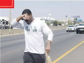  ?? Picture: Tracy Lee Stark ?? STILL FAR. Mcebo Dlamini is pictured near the Woodmead off-ramp, walking from Wits to the Union Buildings in Pretoria to submit a letter of demands to the presidency. He is asking for the release of students arrested during the #FeesMustFa­ll movement.