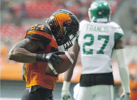  ?? GERRY KAHRMANN ?? The B.C. Lions’ Jeremiah Johnson celebrates his touchdown as the Saskatchew­an Roughrider­s Kevin Frances walks away in a pre-season CFL football game at BC Place, Vancouver, on Friday. The Riders looked bad in receiving a 42-10 clawing from the Lions,...