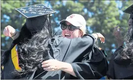  ?? MARITZA CRUZ — STAFF PHOTOGRAPH­ER ?? Shellie Barber hugs Dallas Swayzer during Santa Clara University’s 2018 commenceme­nt on Saturday. Barber works in the career center where Swayzer worked as a student assistant.