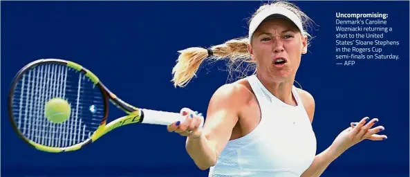  ??  ?? Uncompromi­sing: Denmark’s Caroline Wozniacki returning a shot to the United States’ Sloane Stephens in the Rogers Cup semi-finals on Saturday. — AFP