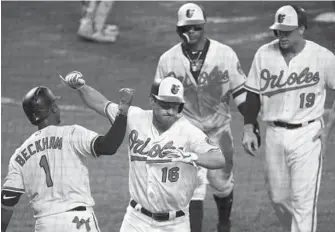  ?? PATRICK SEMANSKY/ASSOCIATED PRESS ?? The Orioles’ Trey Mancini celebrates his three-run home run with teammate Tim Beckham in the sixth inning. Mancini added a two-run double in the seventh to match a career high with five RBIs.