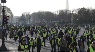  ?? - AFP file photo ?? PROTEST: People walk on the Concorde square in Paris, during a nationwide popular initiated day of protest called ‘yellow vest’ movement to protest against high fuel prices.