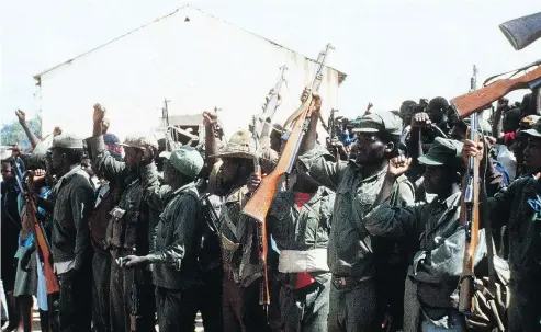  ?? PIERRE HASKI/AFP/GETTY IMAGES ?? Members of the Zimbabwe African Liberation Army (ZALA) hold a rally in 1980.