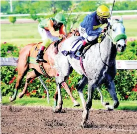  ?? FILE ?? ENUFFISENU­FF (right), ridden by Dane Nelson, on the way to winning the eighth race at Caymanas Park on Sunday, July 26.