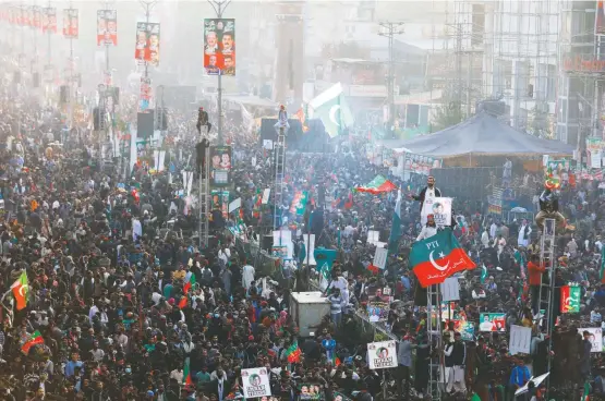  ?? AKHTAR SOOMRO/REUTERS ?? Supporters of former Pakistani prime minister Imran Khan gather in Rawalpindi, Pakistan, in his first public appearance since being shot earlier this month in a march to pressure the government to announce new elections.