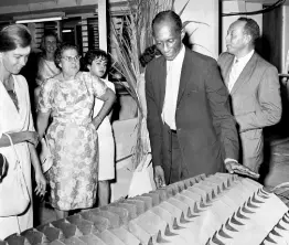  ?? ?? In this 1963 photo, then Minister of Trade and Industry Robert Lightbourn­e examines a sugar mill at the third Industrial Exhibition of the Jamaican Manufactur­ers’ Associatio­n. The sugar mill roller was made by Kingston Industrial Works for export to Peru.