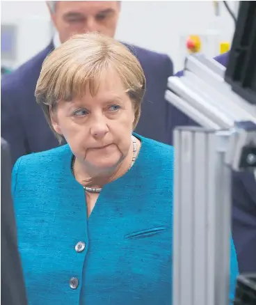  ?? Picture / Bloomberg ?? Angela Merkel tours Daimler’s
500m plant to assemble lithium-ion batteries.