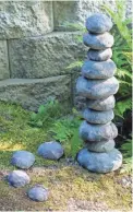  ?? JOANN MOSER ?? Held in place by a rebar stake, this easy-to-make faux rock cairn won’t topple over.