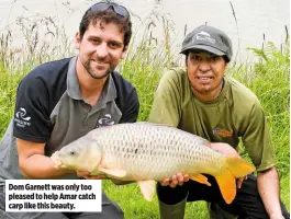  ??  ?? Dom Garnett was only too pleased to help Amar catch carp like this beauty.