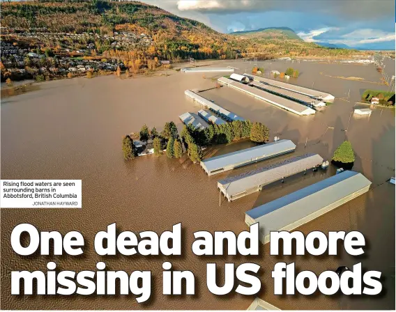  ?? JONATHAN HAYWARD ?? Rising flood waters are seen surroundin­g barns in Abbotsford, British Columbia