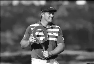 ?? The Associated Press ?? BIRDY FOR THE WIN: Bryson DeChambeau holds the Rocket Mortgage Classic trophy Sunday at Detroit Golf Club in Detroit. DeChambeau won the tournament by three strokes for his first victory of the season and sixth overall.