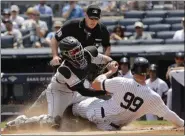  ?? FRANK FRANKLIN II - THE ASSOCIATED PRESS ?? Colorado Rockies catcher Tony Wolters, left, tags out New York Yankees’ Aaron Judge, right, during the first inning of a baseball game as home plate umpire Chris Conroy watches Saturday, July 20, 2019, in New York.