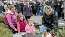  ?? PHOTO: KEVIN STENT/FAIRFAX NZ ?? Brendon Scheib, below, died in a lift shaft last year. His daughter Louise Foster, left, granddaugh­ters Ella Scheib and Abigail Foster and wife Deb lay flowers at the Wellington Workers Memorial.