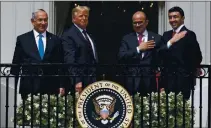  ?? ALEX BRANDON — THE ASSOCIATED PRESS ?? Israeli Prime Minister Benjamin Netanyahu, left, President Donald Trump, Bahrain Foreign Minister Khalid bin Ahmed Al Khalifa and United Arab Emirates Foreign Minister Abdullah bin Zayed al-Nahyan react on the Blue Room Balcony Sept. 15 after signing the Abraham Accords on the South Lawn of the White House in Washington.