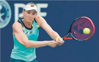  ?? LYNNE SLADKY/AP LATE THURSDAY ?? Elena Rybakina, of Kazakhstan, hits a return to Victoria Azarenka, of Belarus, during a quarterfin­al at the Miami Open on Thursday in Miami Gardens.