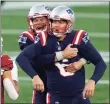  ?? Elise Amendola / Associated Press ?? Patriots kicker Nick Folk, front, celebrates his game-winning field goal with holder Jake Bailey as time expires on Sunday.