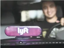  ?? Amy Osborne / Special to The Chronicle ?? Lyft driver Marvin Lopez has the new identifyin­g device, which replaced the pink mustache, on his dashboard.