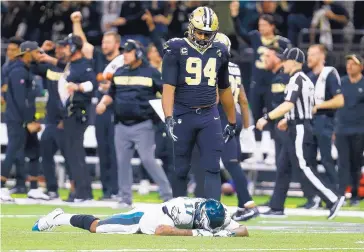  ?? BUTCH DILL/ASSOCIATED PRESS ?? Philadelph­ia Eagles wide receiver Alshon Jeffery (17) lies on the turf in front of New Orleans Saints defensive end Cameron Jordan (94) after the Saints intercepte­d a pass that went through Jeffery’s hands to secure the win.