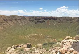  ?? SCOTT CRAVEN/THE REPUBLIC ?? The impact of an iron-nickel meteorite 150 feet wide is still visible 50,000 years later. The Meteor Crater in northern Arizona was the first impact crater to be confirmed by scientists.
