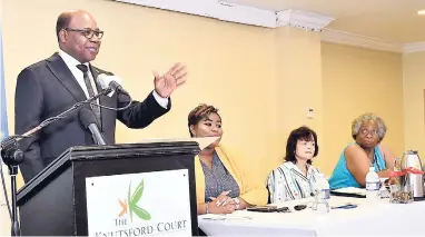  ??  ?? Minister of Tourism the Hon Edmund Bartlett addressing workers during a presentati­on on the Tourism Workers’ Pension Scheme. Listening intently are (from second left) Jhanelle-Rae Bowie, economist in the Ministry of Tourism; Camille Needham, executive...