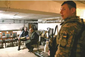  ?? Reuters-Yonhap ?? European Council President Charles Michel and Ukrainian Prime Minister Denys Smyhal wait inside a bomb shelter amid air raid sirens in Odesa, Ukraine, Monday.