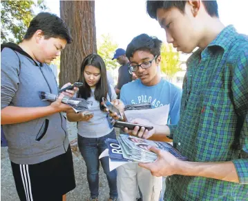  ?? KARL MONDON/STAFF ?? Hayes Yang, Brigitte Jia, Ronuk Ray and James Kho coordinate their phones Sept. 18 before canvassing for Ro Khanna, a candidate seeking to become the first Indo-American to represent the Bay Area in Congress.