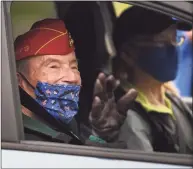  ??  ?? World War II veteran Richard Steele, 98, of Stratford, waves as he is driven up to receive a Veterans Day drive-thru breakfast at the Baldwin Community Center in Stratford on Wednesday.