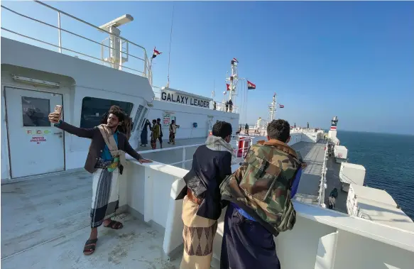  ?? Reuters ?? People tour the deck of the Galaxy Leader, a Bahamas-flagged cargo vessel seized by the Houthi rebels in the Red Sea last month